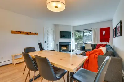 a living room with a table and a couch at Walk to Winter Park Bus From Fraser Condo! in Fraser