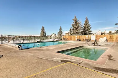 a swimming pool in the middle of a parking lot at Walk to Winter Park Bus From Fraser Condo! in Fraser