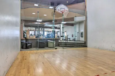 an empty gym with a basketball hoop on a basketball court at Walk to Winter Park Bus From Fraser Condo! in Fraser