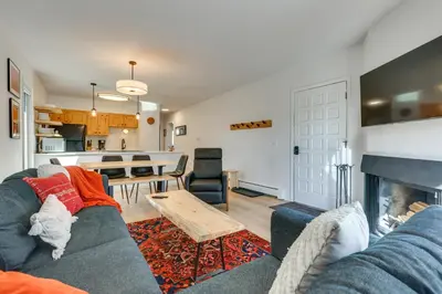 a living room with a couch and a fireplace at Walk to Winter Park Bus From Fraser Condo! in Fraser