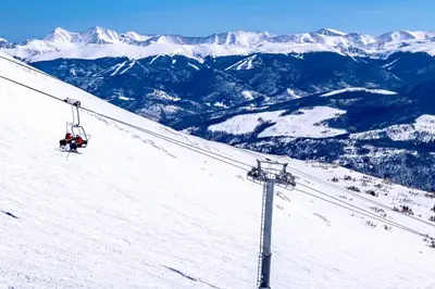 a ski lift going down a snow covered mountain at A Slice of Silverthorne in Silverthorne