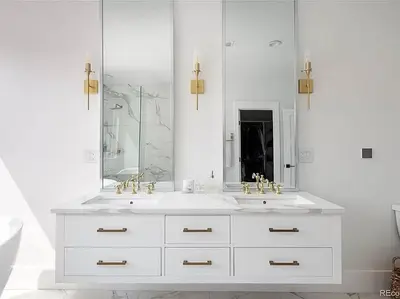 a white bathroom with two sinks and a mirror at New! Pure Luxury W Private Pool/Spa & Game Center! in Arvada