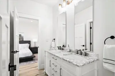 a white bathroom with a sink and a mirror at New! Pure Luxury W Private Pool/Spa & Game Center! in Arvada