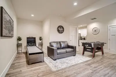 a living room with a leather couch and a piano at New! Pure Luxury W Private Pool/Spa & Game Center! in Arvada