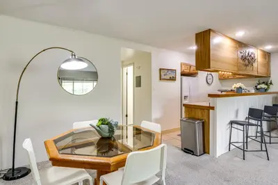 a dining room and kitchen with a glass table and chairs at 6 Mi to Keystone Resort Cozy Lake Dillon Condo! in Dillon