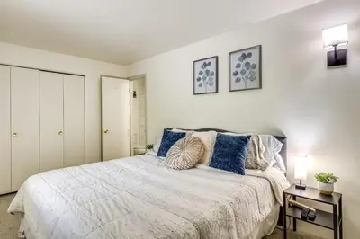 a bedroom with a large bed with blue pillows at 6 Mi to Keystone Resort Cozy Lake Dillon Condo! in Dillon