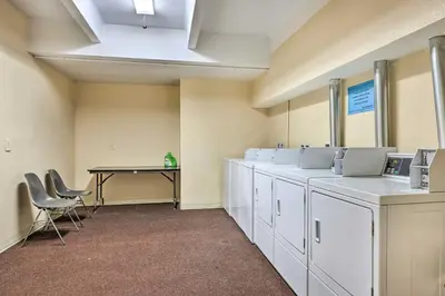 a waiting room with a table and white cabinets at 6 Mi to Keystone Resort Cozy Lake Dillon Condo! in Dillon