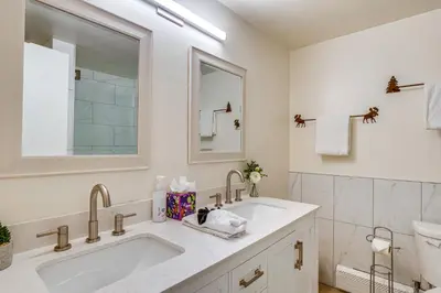a white bathroom with a sink and a mirror at 6 Mi to Keystone Resort Cozy Lake Dillon Condo! in Dillon
