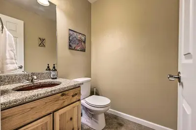a bathroom with a toilet and a sink and a mirror at Fraser Mtn Escape 8 Mi to Winter Park Resort in Fraser