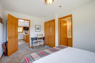 a bedroom with a bed and a desk and a table at Steps to Grand Lake New Deck at The Innlet Condo in Grand Lake