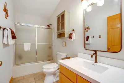 a bathroom with a sink and a toilet and a mirror at Steps to Grand Lake New Deck at The Innlet Condo in Grand Lake