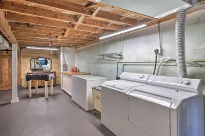 a kitchen with white appliances in a room with wooden ceilings at Forest-View Creekside Cabins with 4 Acres! in Evergreen
