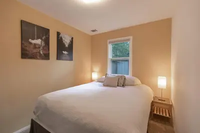 a bedroom with a bed with two lamps and a window at Galena Getaway: Dog-Friendly Frisco Retreat in Frisco