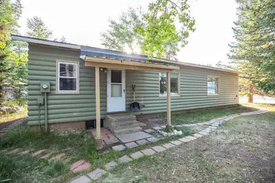 a green tiny house with a porch and stairs at Galena Getaway: Dog-Friendly Frisco Retreat in Frisco
