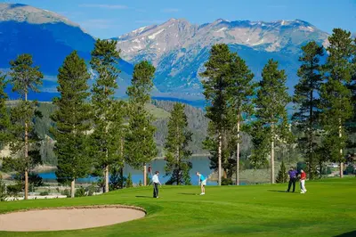 a group of people playing golf on a golf course at Condo on Shuttle Rt-Wild Irishman with Pool and More in Keystone