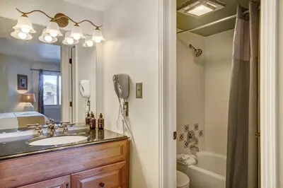 a bathroom with a sink and a toilet and a shower at Condo on Shuttle Rt-Wild Irishman with Pool and More in Keystone