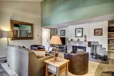 a living room with a couch and a fireplace at Condo on Shuttle Rt-Wild Irishman with Pool and More in Keystone
