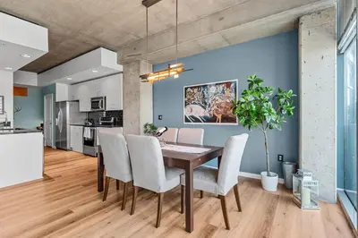 a dining room with a wooden table and chairs at 1700 Bassett, Unit 818 in Denver