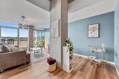 a living room with blue walls and a couch at 1700 Bassett, Unit 818 in Denver