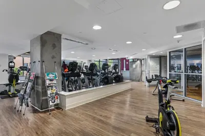 a gym with treadmills and bikes in a room at 1700 Bassett, Unit 818 in Denver