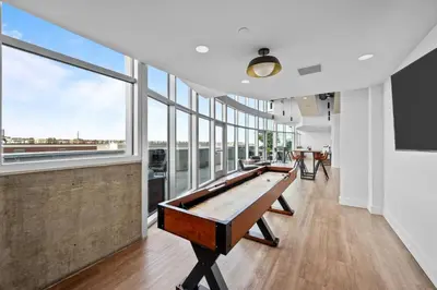 a pool table in a room with large windows at 1700 Bassett, Unit 818 in Denver