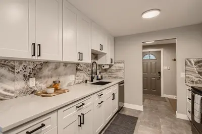 a kitchen with white cabinets and a sink at 6636 Depew St (upper) in Arvada