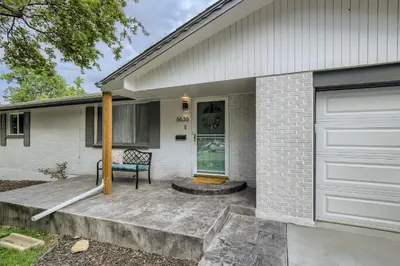 a front porch of a house with a bench on it at 6636 Depew St (upper) in Arvada