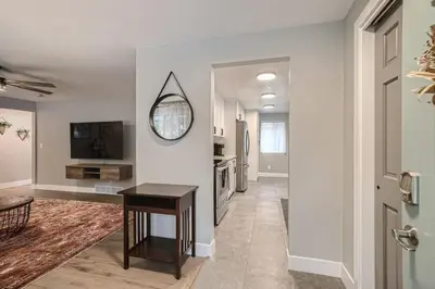 a living room with a table and a mirror at 6636 Depew St (upper) in Arvada