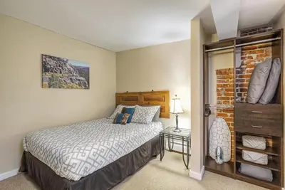 a bedroom with a bed and a dresser in it at 2193 Arapahoe St Unit 17 in Denver