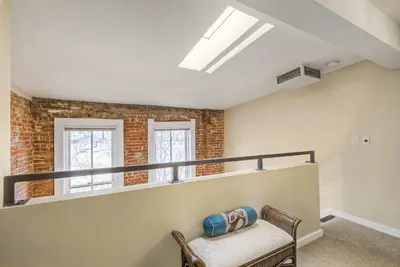 a living room with a bench and a window at 2193 Arapahoe St Unit 17 in Denver