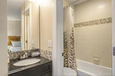 a bathroom with two sinks and a shower at 2193 Arapahoe St Unit 17 in Denver