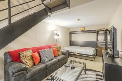 a living room with a couch and a bunk bed at 2193 Arapahoe St Unit 17 in Denver