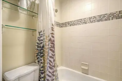 a bathroom with a tub and a toilet and a shower at 2193 Arapahoe St Unit 17 in Denver