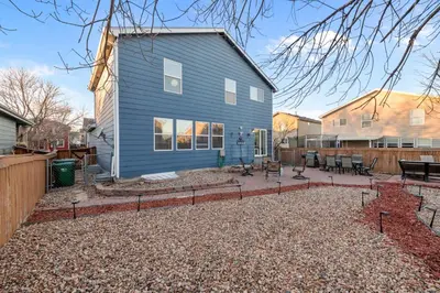 a blue house with a patio in front of it at 1130 Mockingbird St in Brighton
