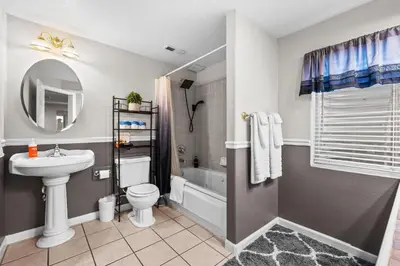 a bathroom with a sink and a toilet and a tub at 1130 Mockingbird St in Brighton