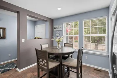 a dining room with a table and chairs at 1130 Mockingbird St in Brighton