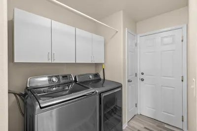 a small laundry room with a washer and dryer at 1130 Mockingbird St in Brighton