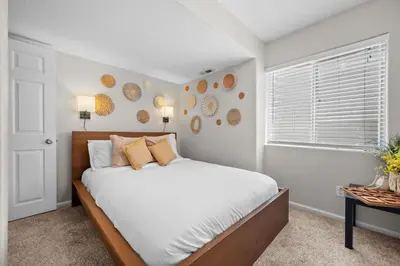 a bedroom with a large bed and a window at 1130 Mockingbird St in Brighton