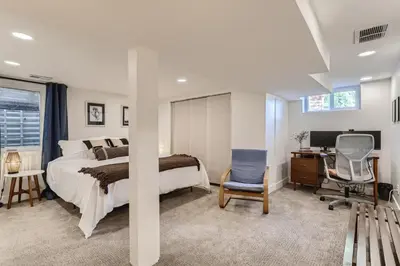 a bedroom with a bed and a desk and a chair at 2375 Ivanhoe St - Entire House in Denver