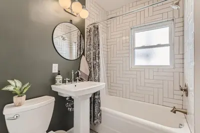 a bathroom with a sink and a toilet and a mirror at 2375 Ivanhoe St - Entire House in Denver