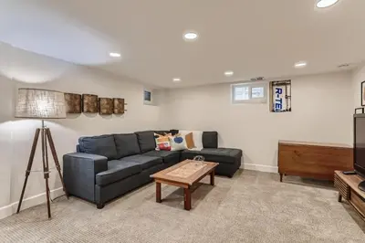 a living room with a blue couch and a table at 2375 Ivanhoe St - Entire House in Denver