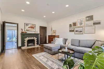 a living room with a couch and a fireplace at 2375 Ivanhoe St - Entire House in Denver