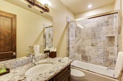 a bathroom with a sink and a toilet and a shower at Rocky Fells Lodge in Breckenridge
