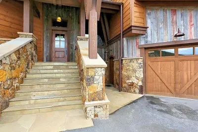 a house with a wooden door and a staircase at Rocky Fells Lodge in Breckenridge