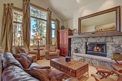 a living room with a couch and a fireplace at Moose Crossing Lodge in Breckenridge