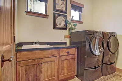 a kitchen with a sink and a washing machine at Moose Crossing Lodge in Breckenridge