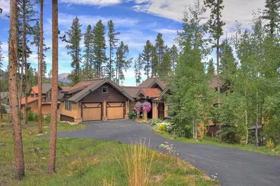 a house with a driveway leading to a garage at Moose Crossing Lodge in Breckenridge