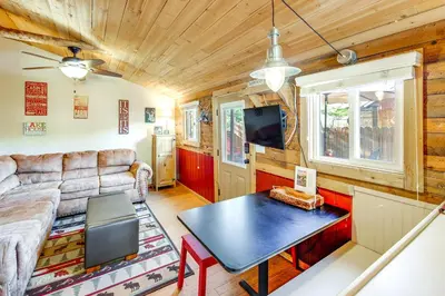 a living room with a couch and a table at 1 Mi to Grand Lake Pet-Friendly Cabin with Grill! in Grand Lake