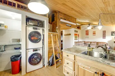 a kitchen with a sink and a washer and dryer at 1 Mi to Grand Lake Pet-Friendly Cabin with Grill! in Grand Lake