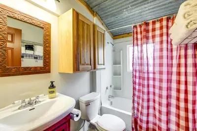 a bathroom with a sink and a toilet and a shower at 1 Mi to Grand Lake Pet-Friendly Cabin with Grill! in Grand Lake